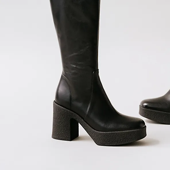 Platform boots in black aged leather